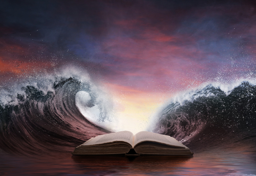 The waves of the ocean are surrounding a book