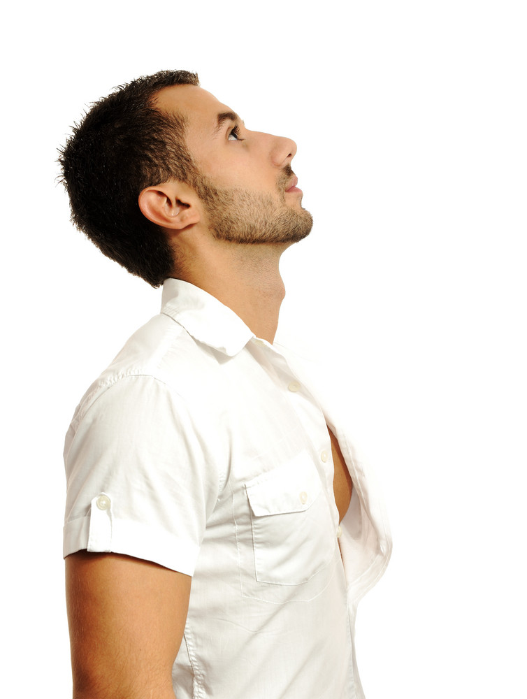 Thoughtful casual man looking up  isolated over a white  