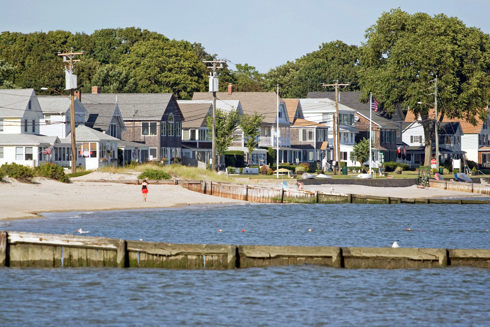 View Of The New England Coastline With A Long Row Of Beach