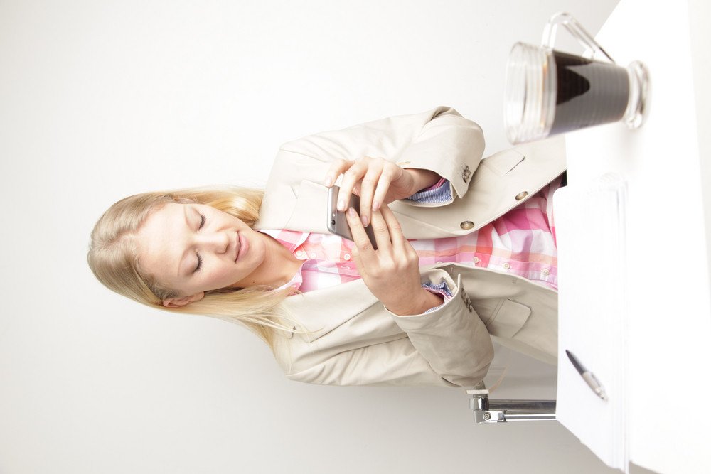 Woman looking at phone and working