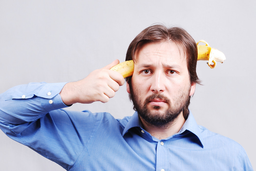 young-man-blowing-up-his-brain-with-banana-royalty-free-stock-image