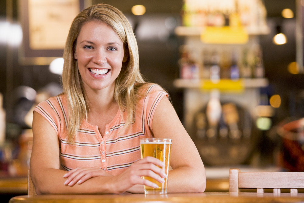 Young Woman Enjoying A Beer At A Bar Royalty Free Stock Image Storyblocks