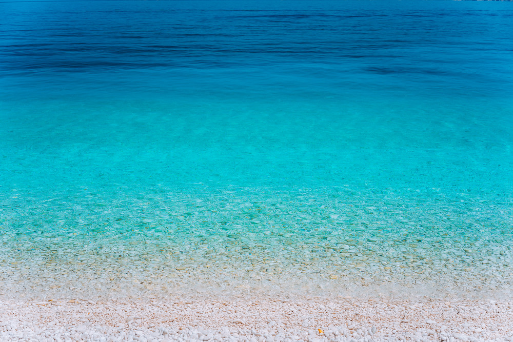 Abstract image of clear blue sea water beautiful background decoration of summer time. Clear transparent water. Play of colours. Wallpaper. Idyllic Summer vacation consept, Greece