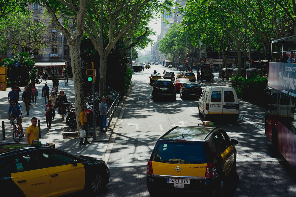 BARCELONA, SPAIN. April 26, 2018: Taxi at the road junction of the historical city of Barcelona in Spain. Classic taxi yellow and black. Hybrid car