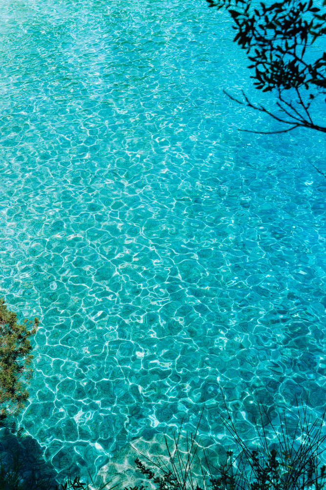 Blue turquoise ripple water in mediterrean bay. The crystal clear sea and sun. Swimming summer time