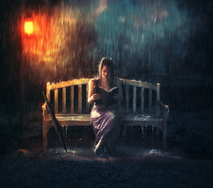 A Woman Read Her Bible Alone In A Rain Storm Royalty Free Stock