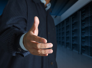 close-up-businessmen-offer-hand-shake-in-a-technology-data-center_f17NstSO_thumb.jpg