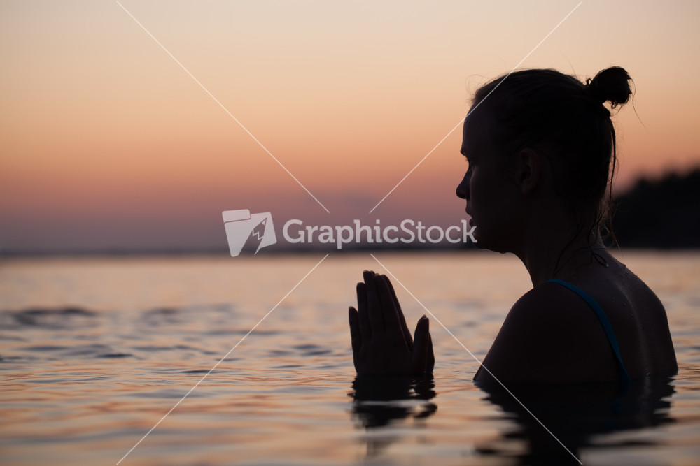 Woman in water during pray or meditation