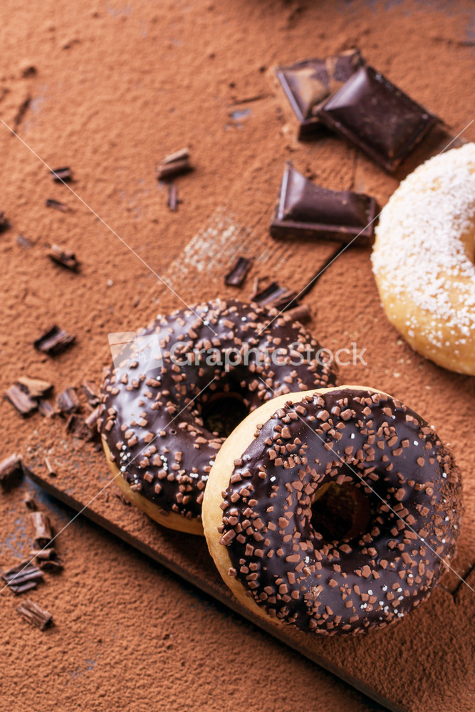 Donuts With Cocoa Powder And Chocolate Stock Image