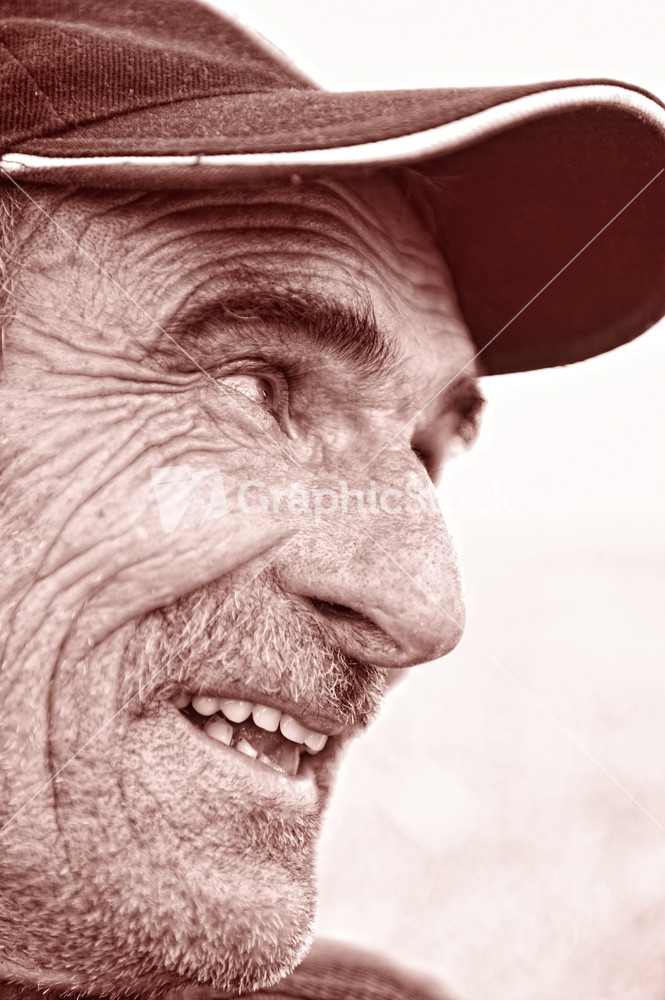 Closeup Profile on a Smiling Old Man With a Grey Beard