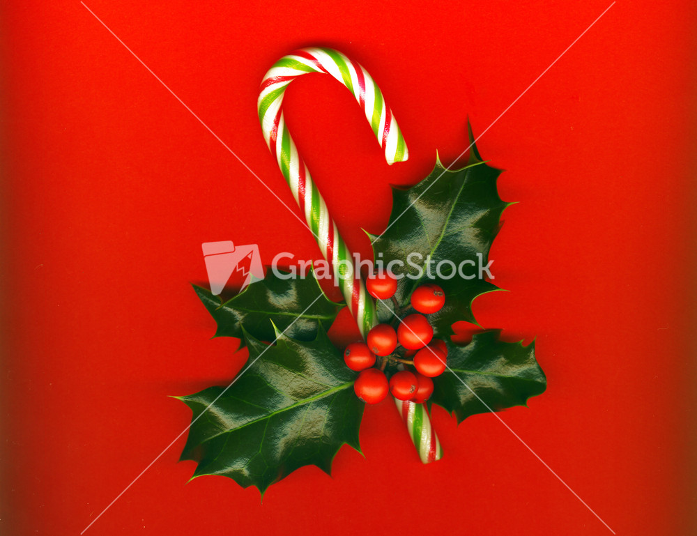 Candy Cane With Pretty Holly Leaves And Berries On Red Background