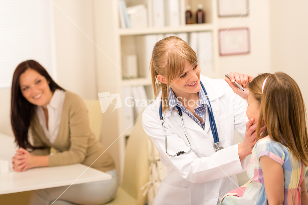 Female pediatrician doing eye check-up to little girl