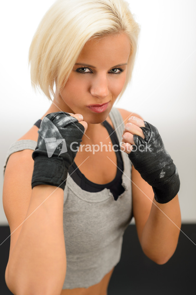 Rough woman ready to fight with boxing bandage gloves