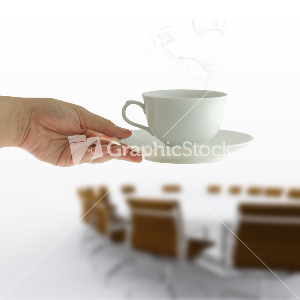 Coffee Cup In Woman Hand On Meeting Table Background