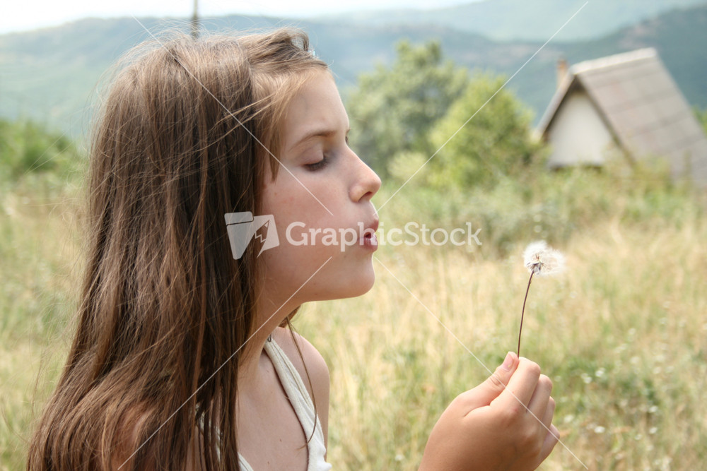 Cute Smiling Little Girl With Dandelion In Her Hands Makes Wish
