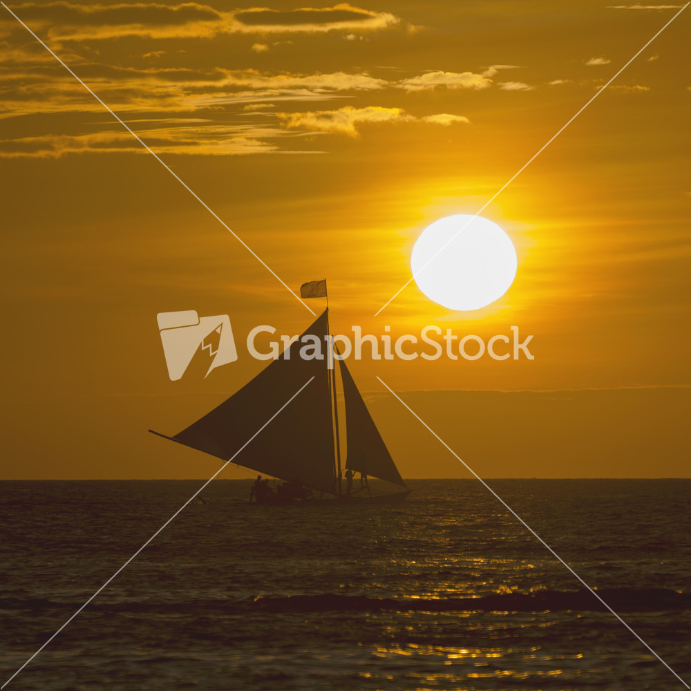 Sailboat on the ocean at sunset