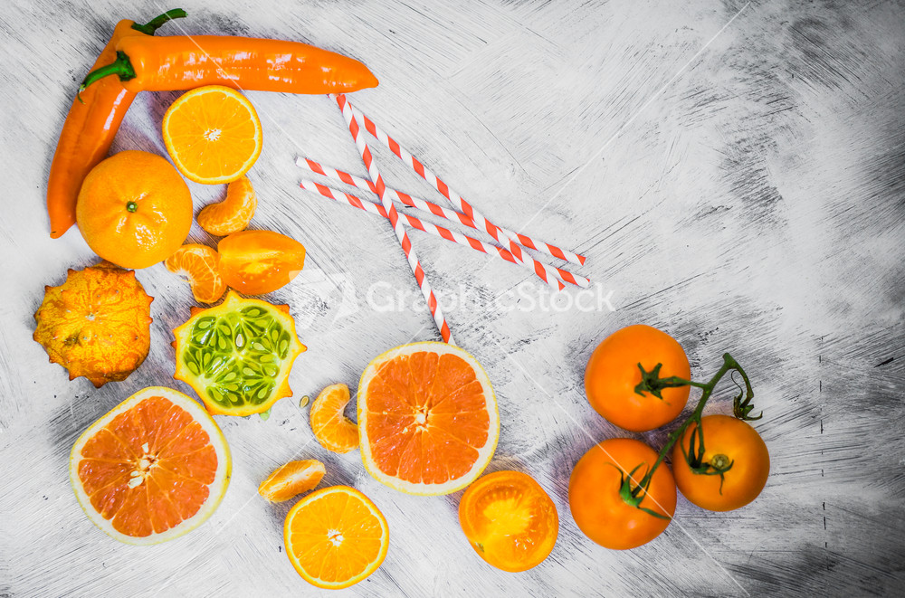 Orange Fruits And Vegetables On Rustic Background