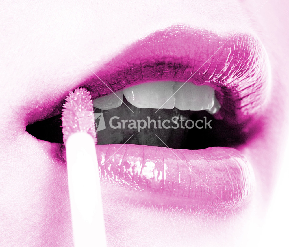 Girl Applying Mauve Lip Gloss To Her Lips