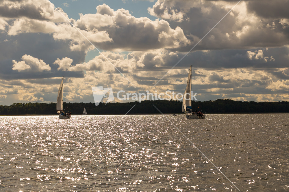 Mamry lake in Poland with sailboats photographed i early autumn. Yacht or boats on beautiful lake in Mazury lake district.