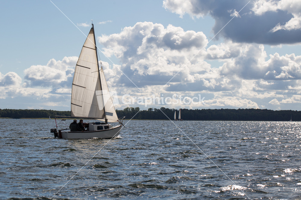 Yacht or boats on beautiful lake in Mazury lake district. Mamry lake in Poland with sailboats photographed i early autumn.