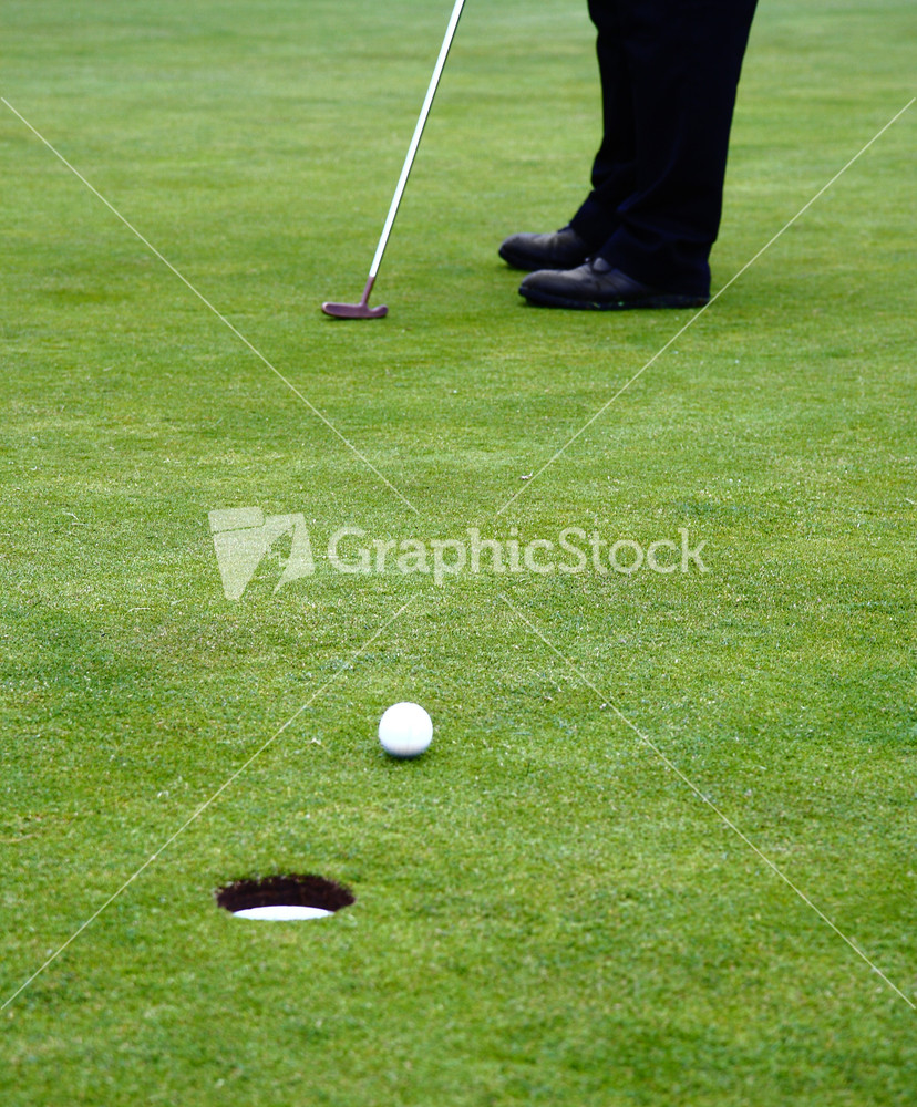 Putting A Golf Ball On The Putting Green