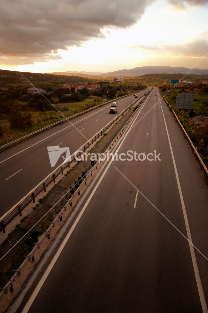 Road And The Cloudy Sunset Sky